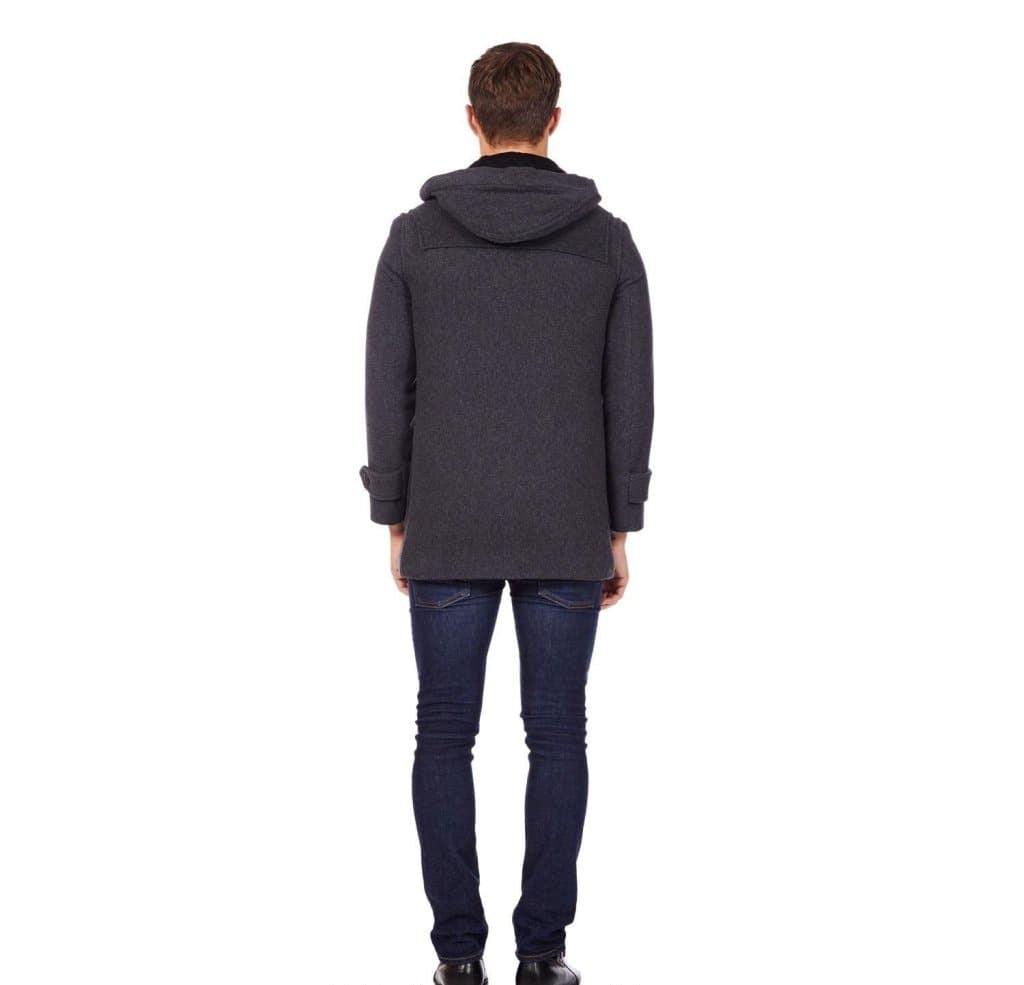 Person wearing a dark gray coat and jeans on a white background with 'De La Creme Fashions' branding.