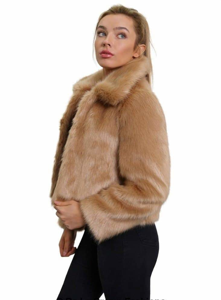 Woman wearing a beige fur coat on a white background