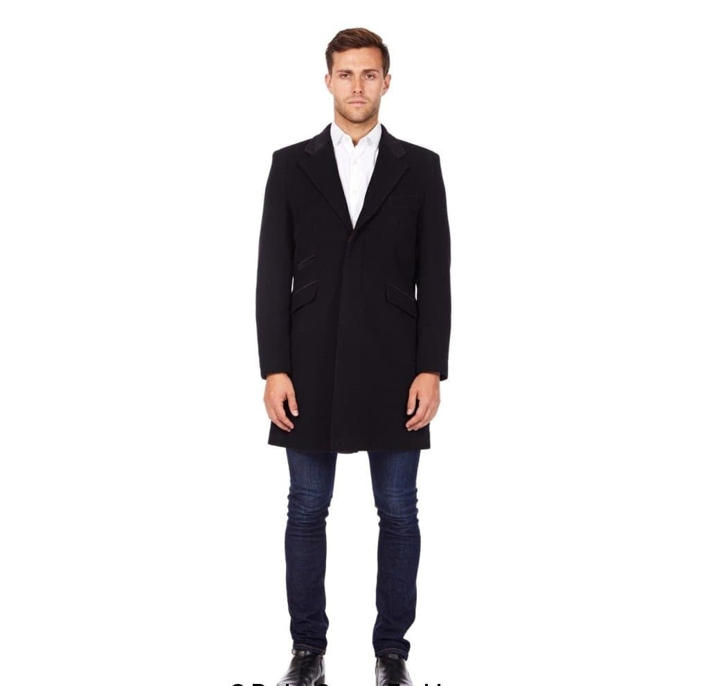 Man wearing a black coat over a white shirt and jeans on a white background
