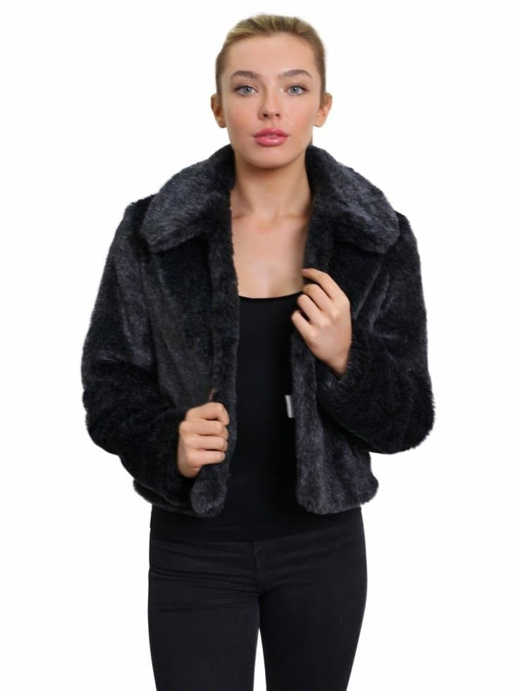 Woman wearing a black fur jacket on a white background